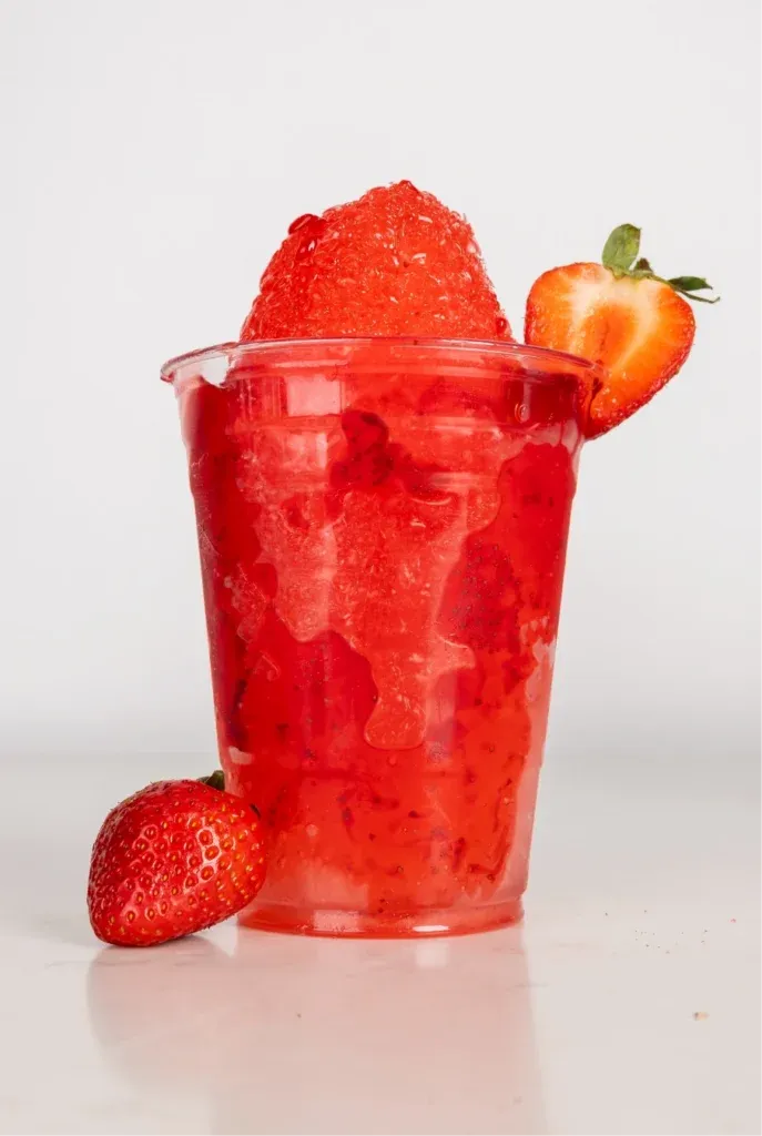 Strawberry raspado topped with fresh strawberries